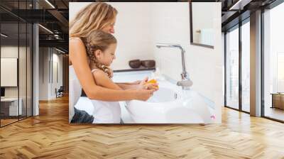 Mother and daughter washing their hands Wall mural