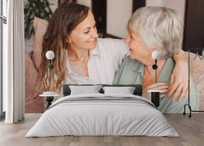 Older mature mother and grown millennial daughter laughing embracing, caring smiling young woman embracing happy senior middle aged mom Wall mural