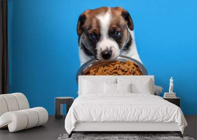 Puppy eats dog food from a bowl Wall mural