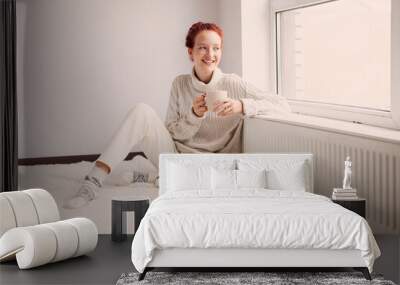 Young Woman Drinking hot coffee at white room Wall mural