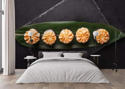 Maki Sushi Roll for Christmas on a green bamboo leaf. Wall mural