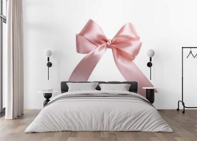 Pink bow isolated on white background. A product made of satin ribbon for decorating a gift. Wall mural