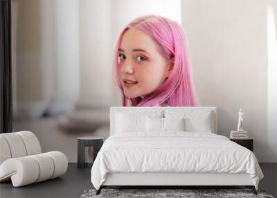 Portrait of a positive pink-haired teenage girl in a white T-shirt.Street style.Summer concept.Generation Z style.Copy space for text. Wall mural