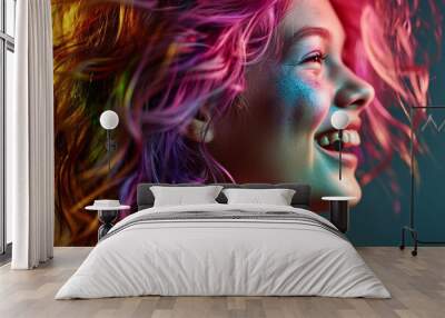 profile portrait of a young beautiful bright fashionable girl with colorful hair and shiny makeup, the model laughs Wall mural