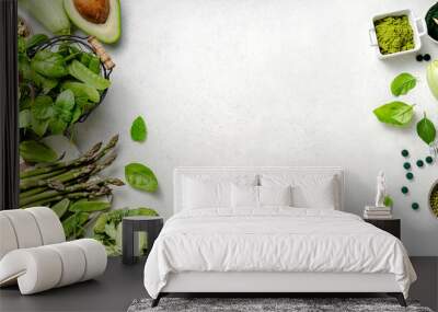 Vegetarian healthy green food on white background. Products for vegans and vegetarians with protein. Green peas, beans, mung beans, broccoli, zucchini, avocados, matcha, spinach, spirulina. Wall mural