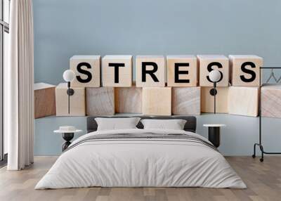 The inscription stress on wooden cubes isolated on a light background, the concept of business and finance. Wall mural