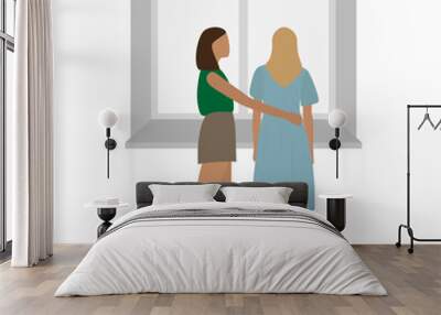 Two young women stand at the window and hug on a white background Wall mural