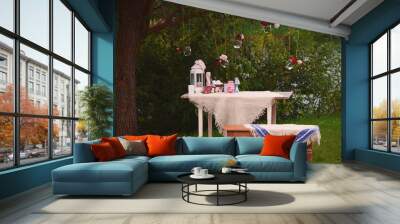 Table and bench in nature with decorations and glass jars with f Wall mural