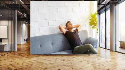 Businessman in casual relaxing on sofa with soft sunlight. Happy life. Breaking time. Wall mural