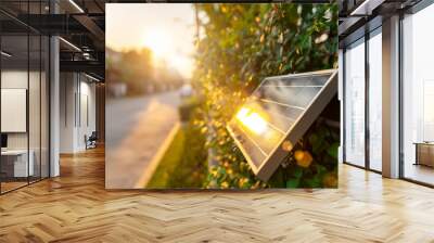 Small solar panel on wall with sunlight. Green energy in home concept. Wall mural