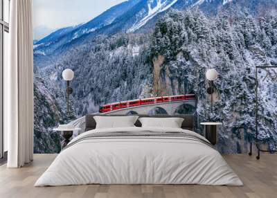 Aerial view of Train passing through famous mountain in Filisur, Switzerland. Landwasser Viaduct world heritage with train express in Swiss Alps snow winter scenery. Wall mural