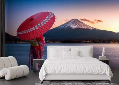 Asian woman wearing japanese traditional kimono at Fuji mountain. Sunset at Kawaguchiko lake in Japan. Wall mural