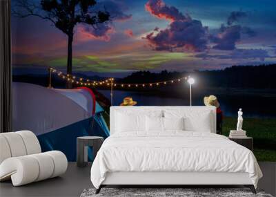 Couple tourists enjoying camping by the lake. Wall mural