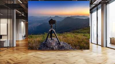 Digital camera on tripod in the mountains. Wall mural