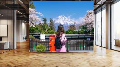 Tourist looking at Fuji mountain and cherry blossom in spring, Fujinomiya in Japan. Wall mural