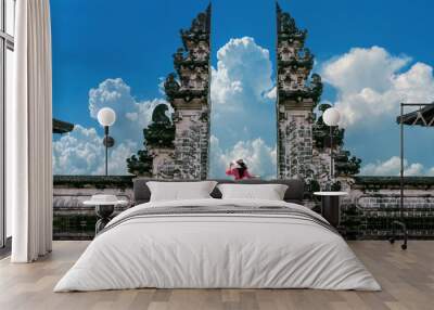 Young woman standing in temple gates at Lempuyang Luhur temple in Bali, Indonesia. Vintage tone. Wall mural