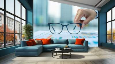 A consultant s hand adjusting glasses while reviewing a business report, glasses adjustment, professional consulting Wall mural