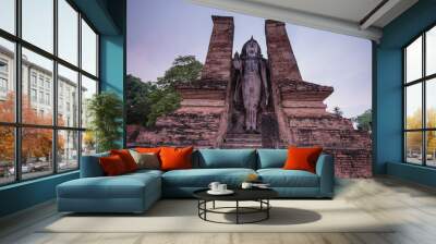 standing ancient sukhothai buddha at dusk, thailand Wall mural