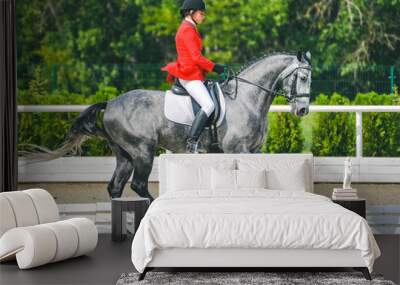 Young elegant rider woman and gray horse, dressage test on equestrian competition. Advanced Dressage test. Horse with girl at dressage equestrian sports competitions. Details of equestrian equipment. Wall mural