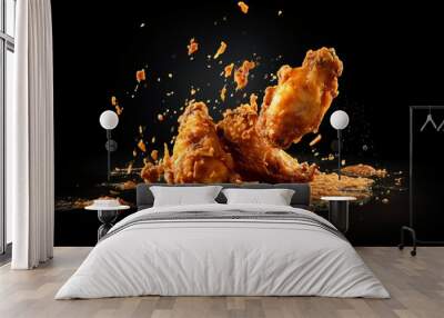 Freeze motion of flying golden brown crispy fried chicken on black background Levitating food Wall mural