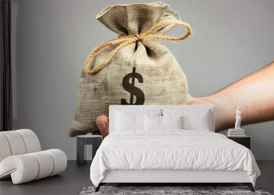 Hand holding money bag, symbolizing financial success, savings, investment, and economic wealth Wall mural