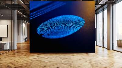 Digital fingerprint scanning technology with glowing blue patterns on a dark background  Wall mural