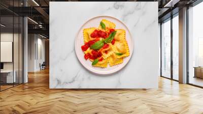 Delicious appetizing ravioli with tomato sauce and basil Wall mural