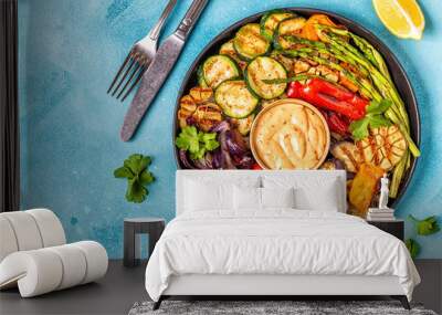 Grilled vegetables on a plate with sauce. Wall mural