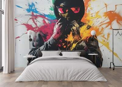 A person wearing a black hooded sweatshirt with sunglasses and a mask is surrounded by splashes of color. Wall mural