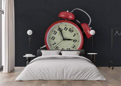 Red alarm clock isolated on a black background. Wall mural