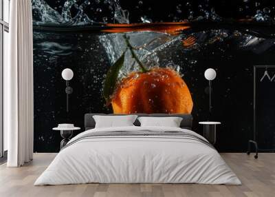 Fresh Clementine falling into the water with a splash on a black background Wall mural