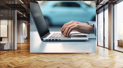 Businessman typing on laptop with car in background. car insurance. car sales, car service. Wall mural