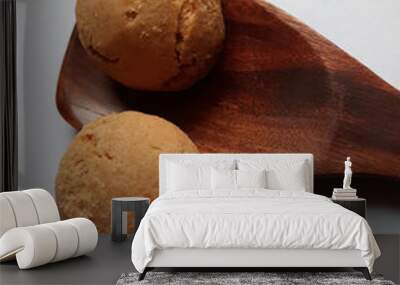 Vertical shot of two freshly baked cookies and a wooden spoon on an isolated background Wall mural