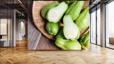 Fresh chayote fruits (Sechium edulis) on wood background Wall mural