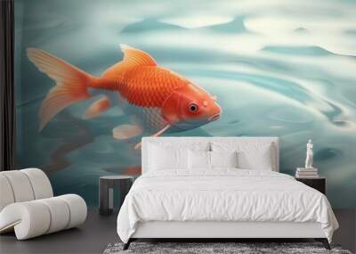 A vibrant goldfish gracefully swimming in clear water, showcasing its striking orange color and delicate fins. Wall mural