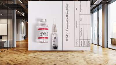 Coronavirus vaccine and vaccination record card on white background Wall mural