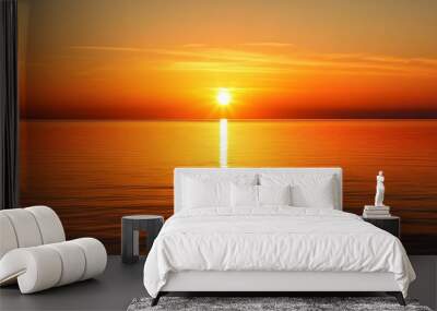 The sun sets in a brilliant golden display over a placid sea, with a warm, amber glow spreading across the horizon. The clear, unobstructed sky enhances the calm, serene atmosphere, and the  Wall mural