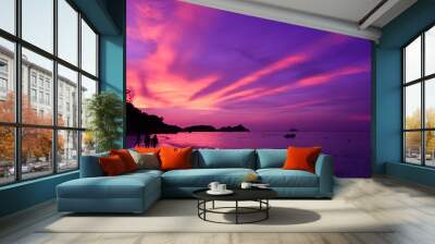 Landscape view of sunset at the beach and few traveller walking along with dramatic sky and sun light ray. Wall mural