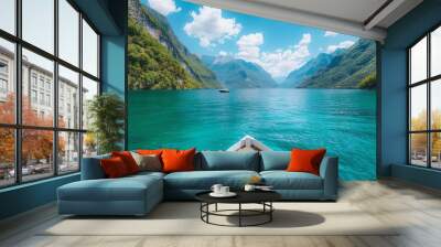 A boat is floating on a lake with mountains in the background Wall mural