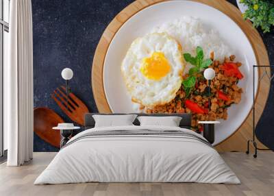 Thai food, stir-fried basil with pork and fried egg Popular food of Thailand, original Thai food concept. Wall mural