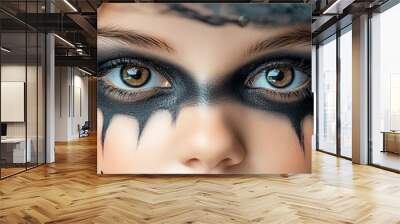 A close-up portrait of a child wearing creative makeup and a witch hat, capturing the essence of Halloween excitement. Wall mural