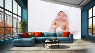 Asian cute baby wearing white towel after taking a shower applying moisturizing cream baby lotion,Childhood baby health  care and skin care concept. Wall mural