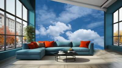 Sky background with dense white clouds on a bright day Wall mural