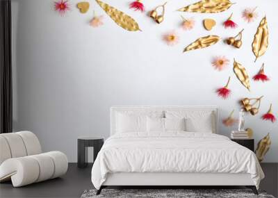 Australian native eucalyptus gold leaves, gum nuts, hearts are decorated with pink & red flowering gum nuts, on a white background. To celebrate Valentines Day, Mothers day, birthday, Anniversary etc. Wall mural