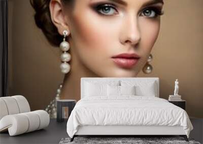 Beautiful young woman with stylish pearl jewelry on beige background Wall mural