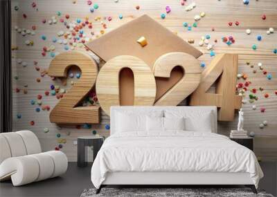 Class of 2024 concept wooden number 2024 with graduated cap and confetti top view. Wall mural