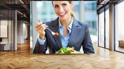 Happy businesswoman eating vegetable salad on lunch break. Wall mural