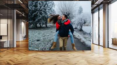 man carries his girlfriend on back Wall mural