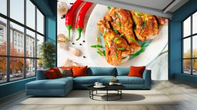 Baked chicken legs on a plate on a white wooden table Wall mural