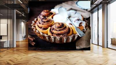 Cinnamon Rolls Baked in Ceramic Mold with Cream Cheese Icing on a Dark Wooden Background Wall mural